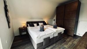a bedroom with a large bed with white sheets at HARMONY "2" stylishes 2 Zimmer Apartment 1 OG Balkon Garten Parkplatz in Gütersloh +31 photos