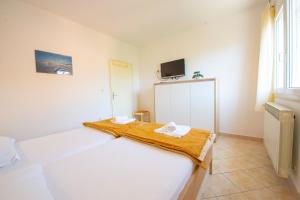 Postel nebo postele na pokoji v ubytování Apartments Cvito