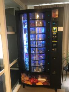 a refrigerator filled with lots of wine bottles at Hostel Snoozemore in Gothenburg