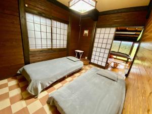 Voodi või voodid majutusasutuse 黒川温泉から車で10分、阿蘇一望の貸切サウナ&一棟貸切宿【Deepspot】 toas