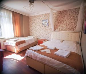 a bedroom with two beds with towels on them at White Palace Büyükada in Adalar +40 photos