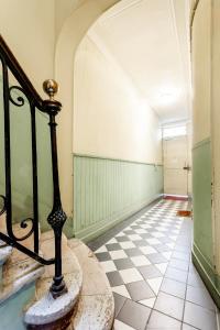 an empty hallway with a staircase and a tiled floor at Lurbe Bleue - Bordeaux central et calme in Bordeaux