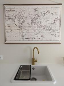 a kitchen sink with a map on the wall at La Mimosa in Puentedeume +24 photos