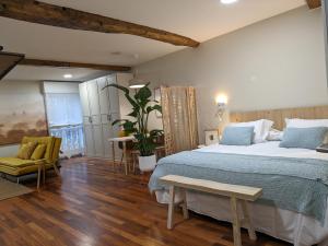 a bedroom with a large bed and a table at La Mimosa in Puentedeume