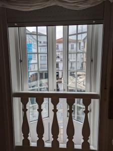a window with a view of a city at La Mimosa in Puentedeume