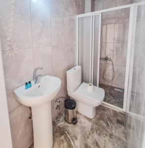 a bathroom with a toilet and a sink at White Palace Büyükada in Adalar