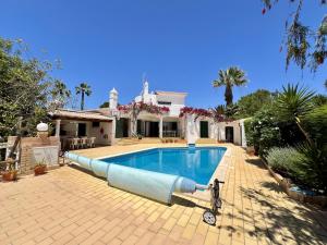 una piscina davanti a una casa di Alvor Traditional Villa With Pool by Homing a Unhais da Serra