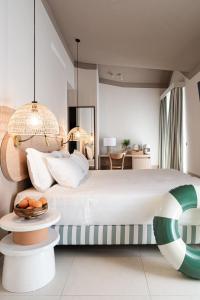 a bedroom with a large bed and a table at Hotel Estense in Gatteo a Mare