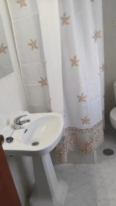 a bathroom with a sink and a shower curtain at Divertida y Romántica in Pegalajar +31 photos