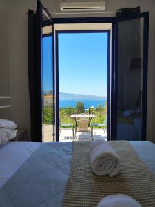 a bedroom with a bed with a view of the ocean at Villaggio Imbesi in Villa San Giovanni