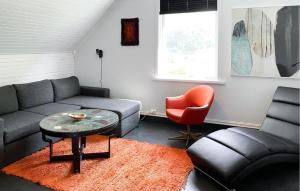 a living room with a couch and a chair at Cozy Home In Austefjorden With Wifi in Austefjorden