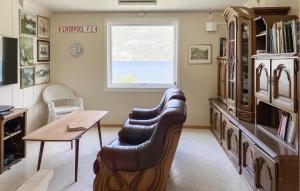 a living room with two leather chairs and a table at Cozy Home In Austefjorden With Wifi in Austefjorden