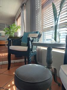 a room with two chairs and a table and a window at Loddey`s Guest House - by Beach Collection in Strand