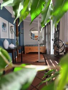 a living room with a table and a mirror at Loddey`s Guest House - by Beach Collection in Strand