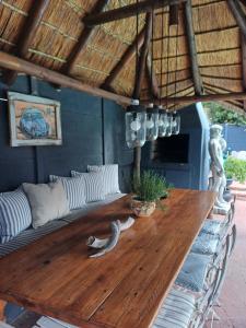a wooden table with a snake on top of it at Loddey's Guesthouse by Beach Collection Winelands in Strand +33 photos