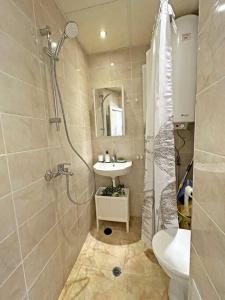 a bathroom with a shower and a sink and a toilet at Beachside Bliss by Mery -Balchik in Balchik
