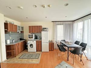 a kitchen and dining room with a table and a refrigerator at Beachside Bliss by Mery -Balchik in Balchik +23 photos