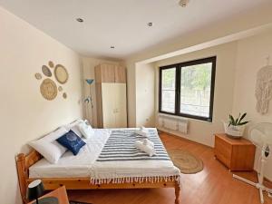 a bedroom with a large bed and a window at Beachside Bliss by Mery -Balchik in Balchik