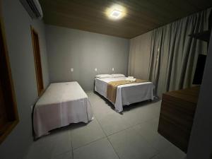 Ein Bett oder Betten in einem Zimmer der Unterkunft POUSADA AMORIM