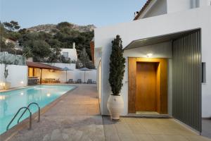 a villa with a swimming pool and a house at Grand Apollon Villa in Sounio