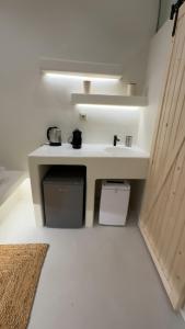 A kitchen or kitchenette at White Sand Jacuzzi Suite