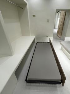A bed or beds in a room at White Sand Jacuzzi Suite