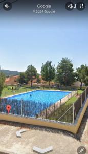 a rendering of a swimming pool in a park at Aventura & Relax Cabañas Peña la Higuera in Villalba de la Sierra