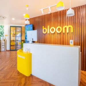 a store with a yellow and white counter and a sign at Bloom Hotel - HSR Layout Sec 6 in Bengaluru