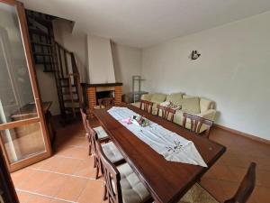 a dining room with a table and a couch at Maya house in Cetona +32 photos