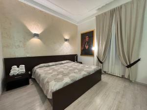 a bedroom with a large bed and a window at Chroma Italy - Chroma Tessera in Rome