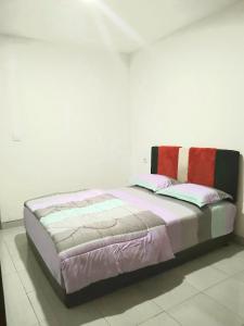 A bed or beds in a room at Eltari Homestay