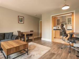 a living room with a couch and a table at Modern, Well Presented 2-Bedroom Apartment, With Parking, Opposite Nirvana Spa in Wokingham