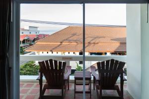 a table and two chairs in front of a window at Neptune's Villa in Haad Rin