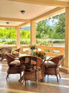 a patio with a table and chairs on a porch at STARS RESIDENCE in Petrovac na Moru