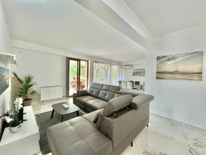 a living room with a couch and a table at STARS RESIDENCE in Petrovac na Moru