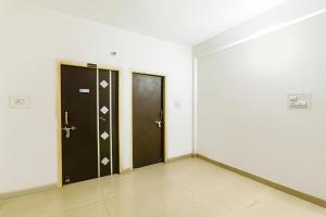 a hallway with two doors in a building at FabExpress The Hudco Grand in Patna