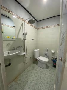 a bathroom with a toilet and a sink at Guest House Pondok Puspa Ayu in Kuta +13 photos