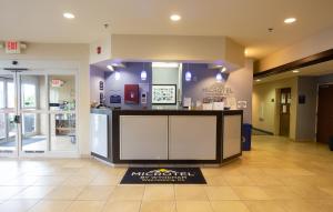 a lobby with a counter in the middle of a store at Microtel Inn & Suites by Wyndham Waynesburg in Waynesburg