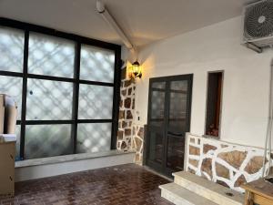 an empty room with a door and a window at Samamà House in Taranto