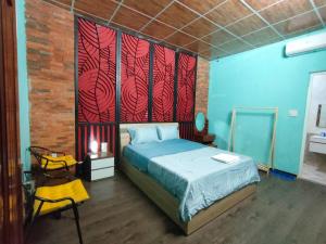 a bedroom with a bed with red and blue walls at DESI DERA Hotel in Da Nang