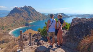 a man and a woman standing on top of a mountain at Khalisa Homestay in Komodo