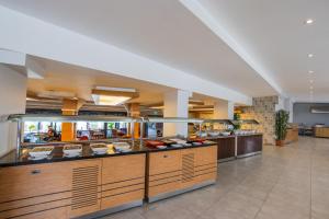 a restaurant with a buffet line with food at point beach hotel in Marmaris