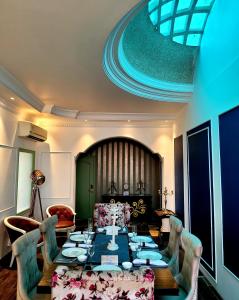 a dining room with a long table and chairs at Victorian Elegance Luxury Stays in Amritsar