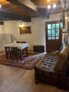 a living room with a couch and a table at Oak Holiday House Nature in Krapje
