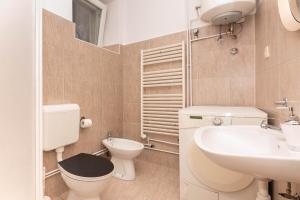 a bathroom with a toilet and a sink at Apartment Hani Koper in Koper +18 photos