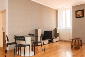 a living room with a table and chairs and a television at Apartment Hani Koper in Koper