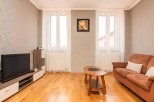 a living room with a couch and a tv at Apartment Hani Koper in Koper