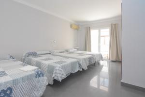 Postel nebo postele na pokoji v ubytování Hostal La Ermita