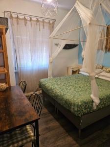 ein Schlafzimmer mit einem Himmelbett in der Unterkunft VILLA VILLACOLLE in Procchio