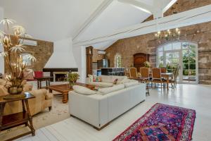 a living room with a white couch and a table at Château Hermitage de Combas in Servian
